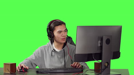 Male-gamer-at-desk-plays-on-computer